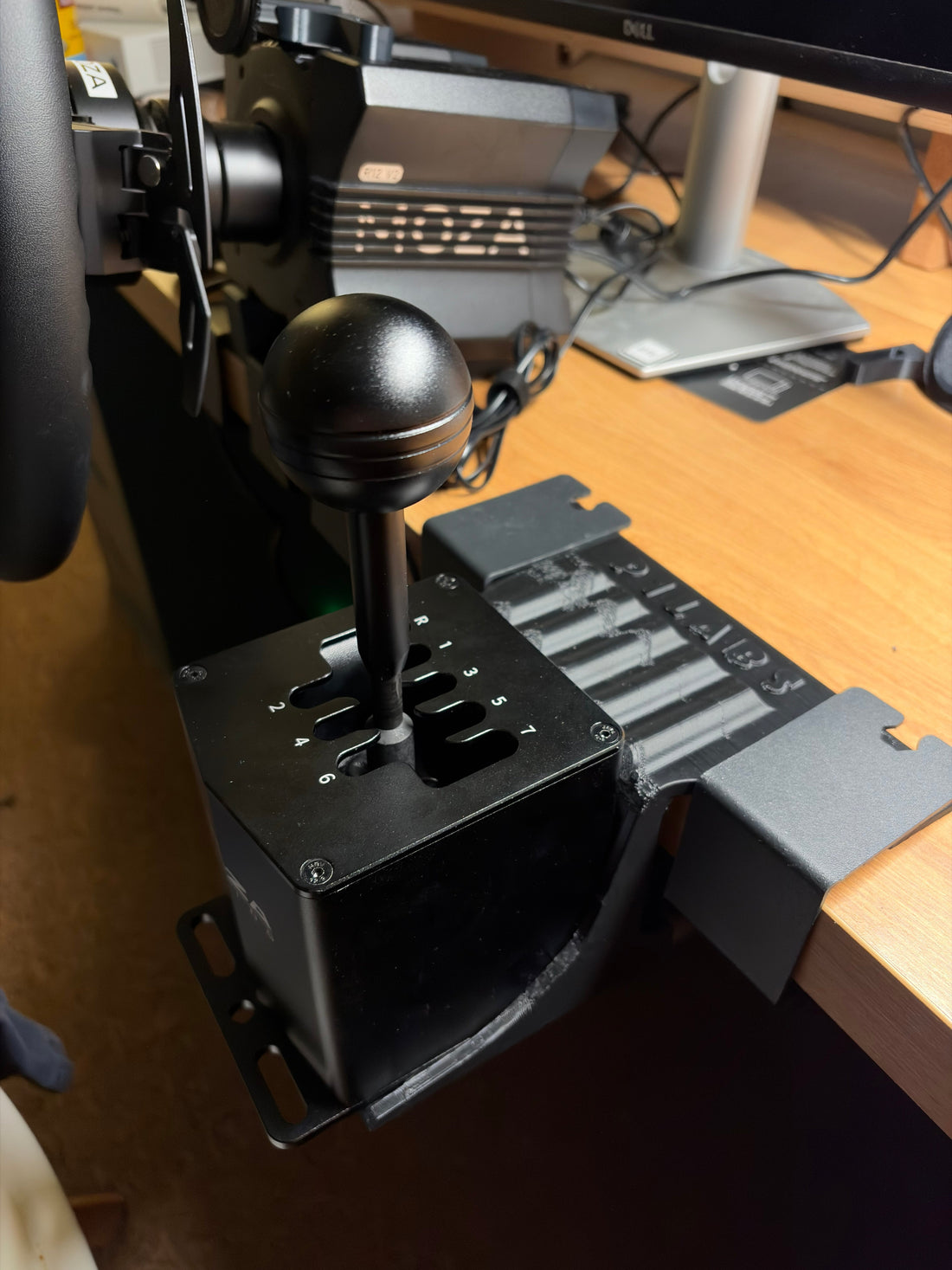 3D printed shifter bracket attached to desk with shifter installed.