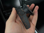 Hand holding a car mount with 'PULABS' branding against a car interior background