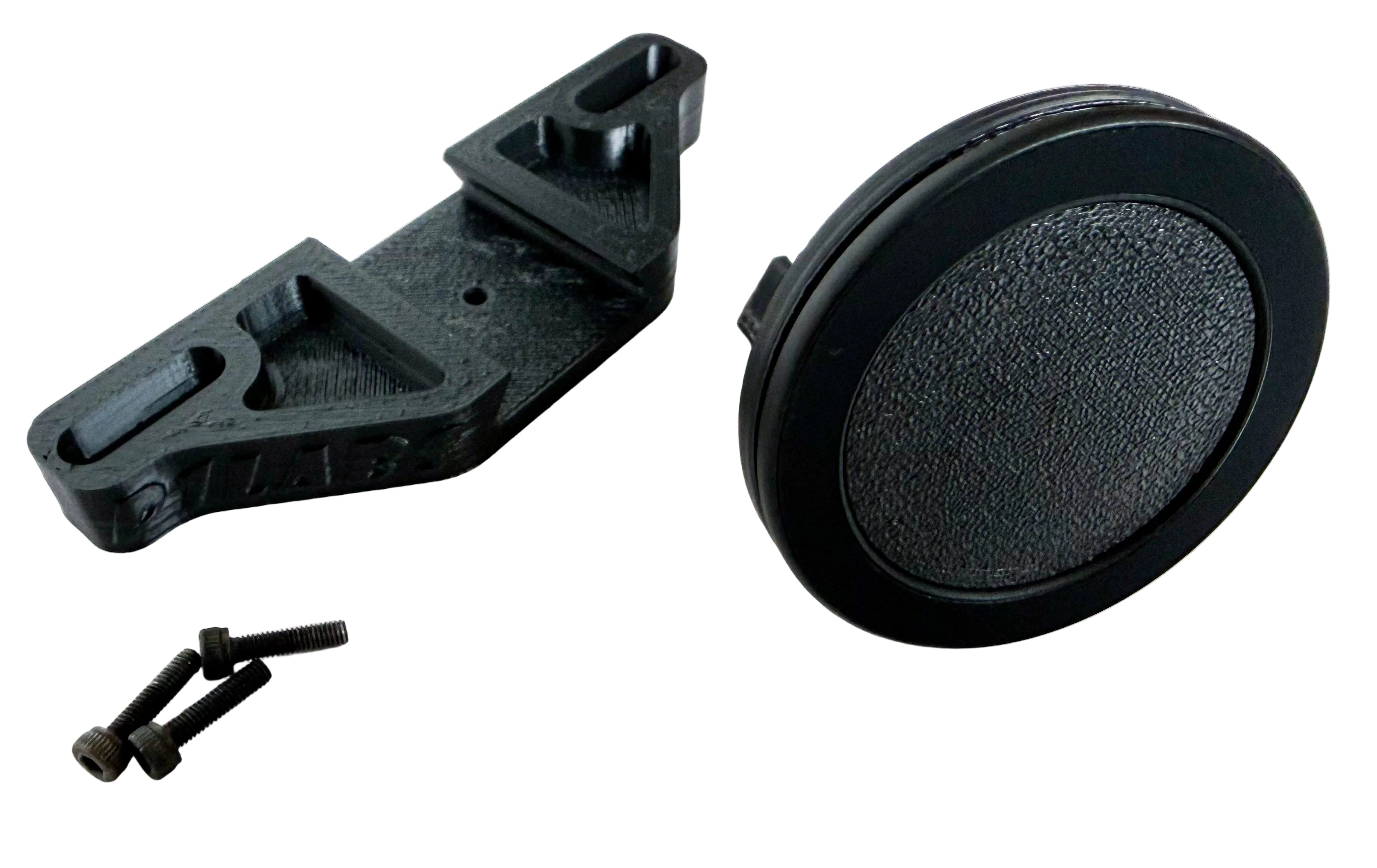 Wheel base phone mount in pieces as received by the buyer. Showing the three screws, base and magnetic ring. A dovetail joint is used to mate the two.