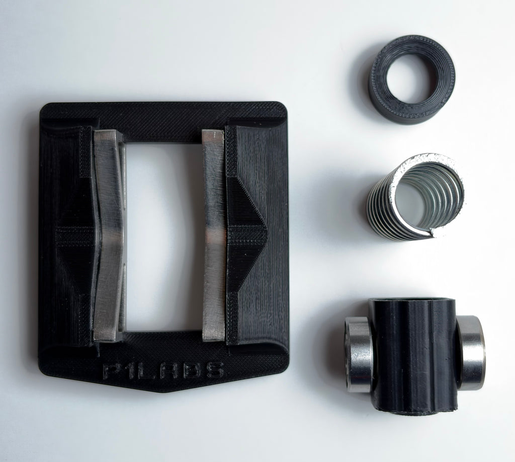 What you get in the box. The base which features stainless steel cams. A bearing block with two heavy duty bearings. A compression spring. A spring seat.